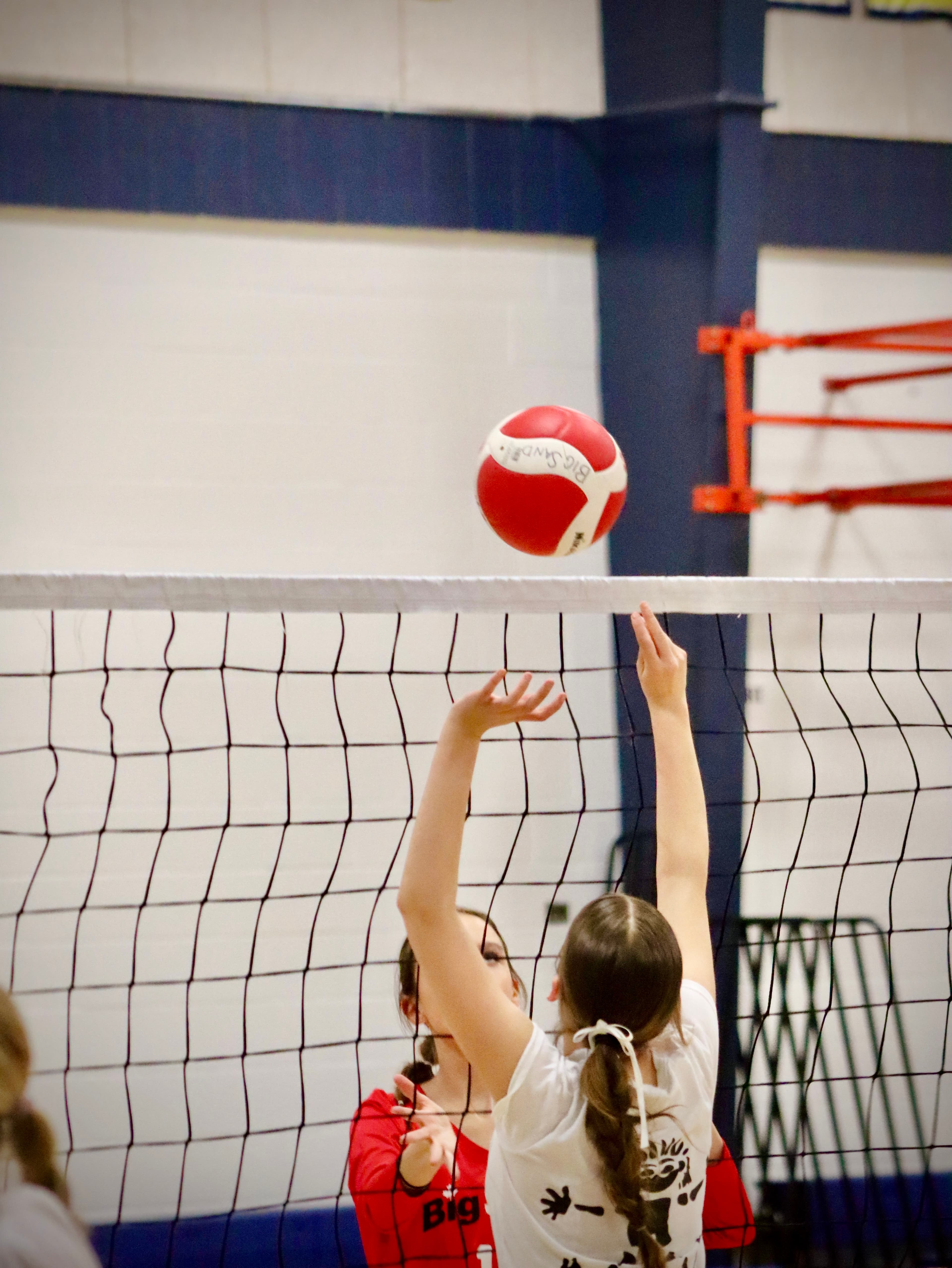 Two girls playing volleyball